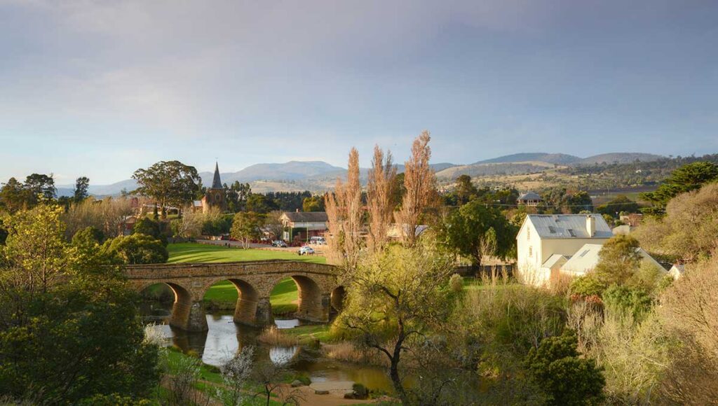 Richmond Bridge in Hobart Australia with lush-greenery and mountains in the background