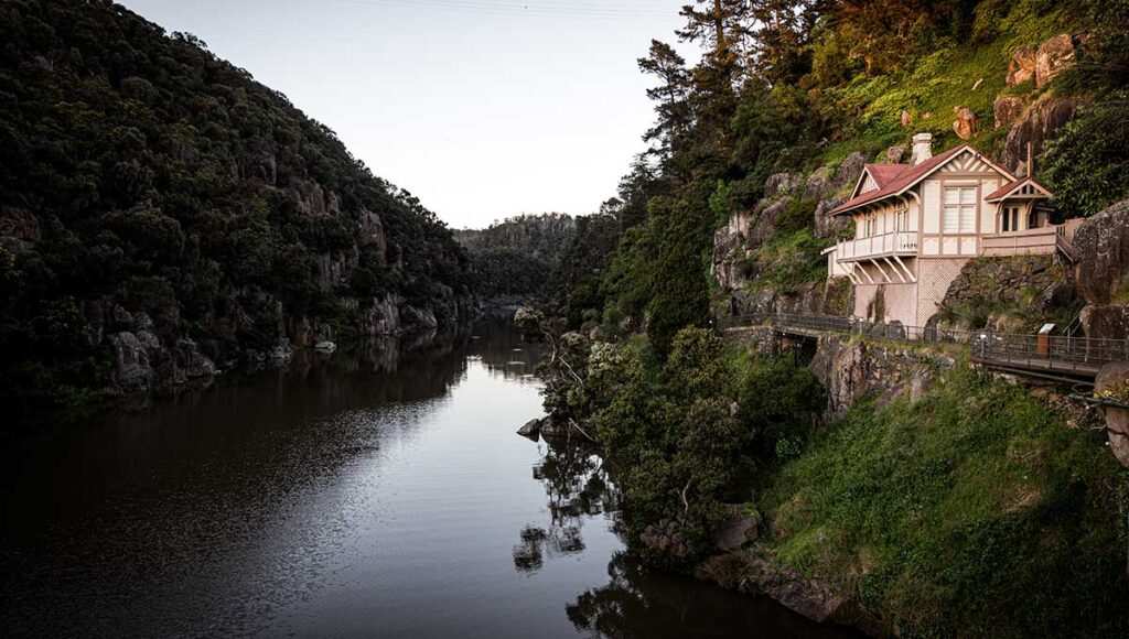 Cataract Gorge with a house on a cliff and a lake