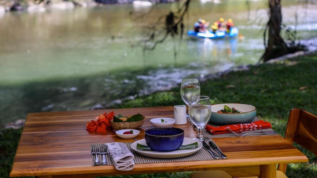 Dining by river at Pacuare Lodge (no children under 7)