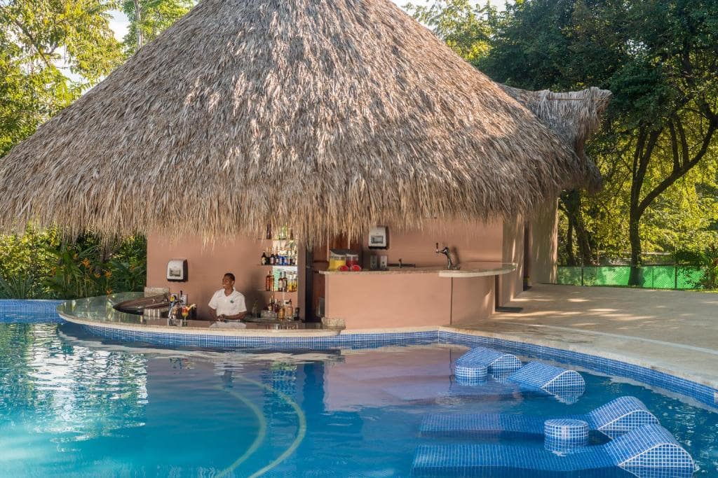 man serving drinks Occidental Papagayo